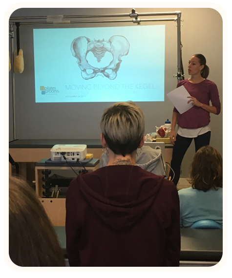 Laura Helsel, Pilates Process Owner, showed teaching a pilates class in a well lit studio, available in Toronto and Vancouver 