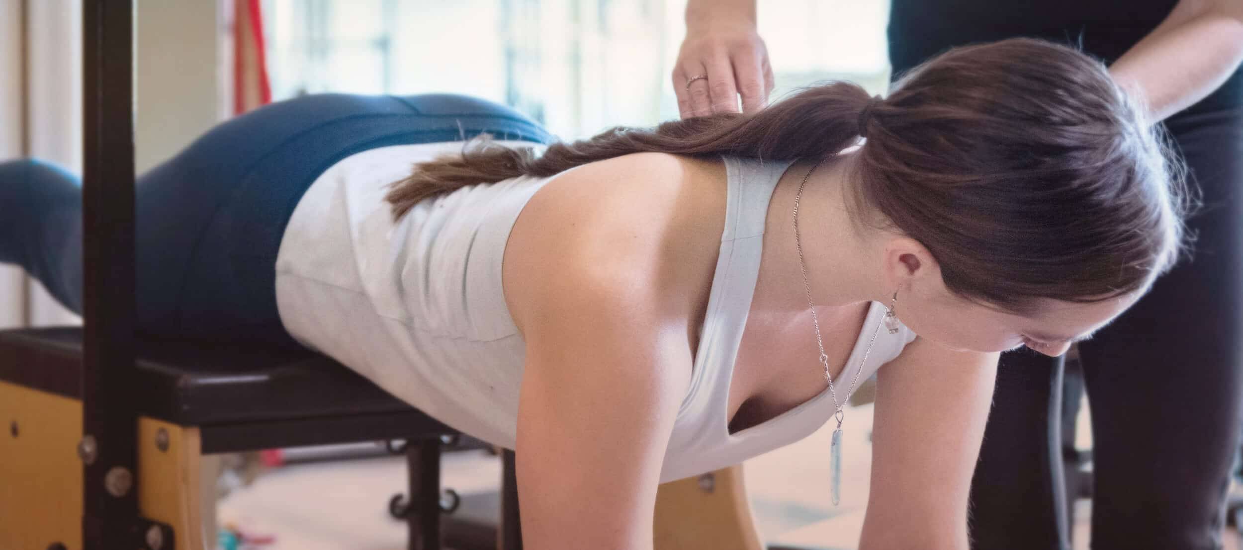 Personal attention being paid to Pilates studio member.